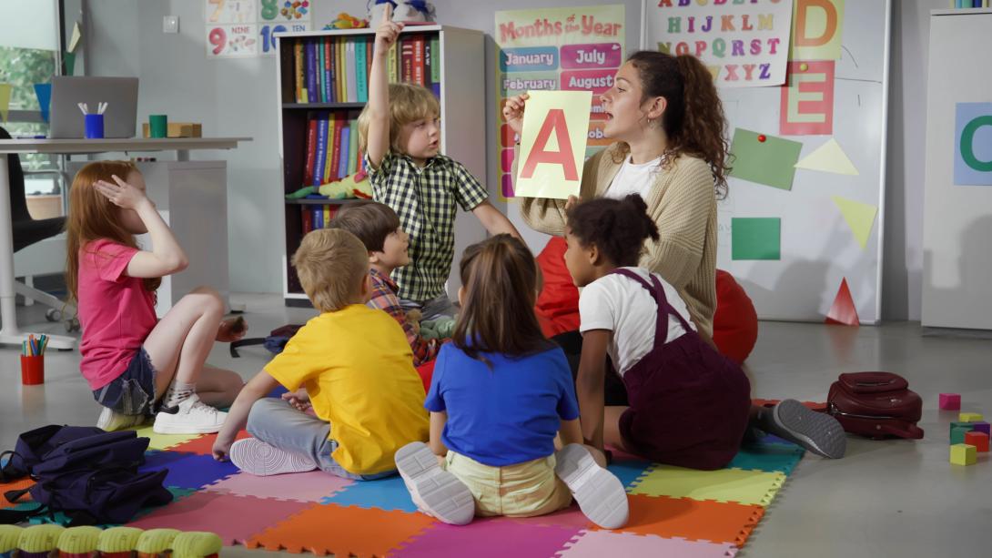 A teacher showing a storybook to a preschool class